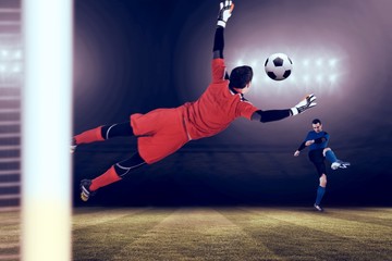 Composite image of fit goal keeper jumping up