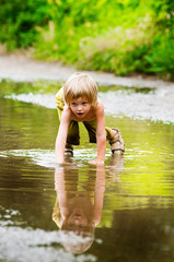 boy playing in puddle