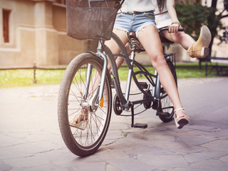 Part of boho girls legs during riding tandem bike