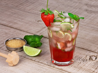 Strawberry mojito cocktail over wooden background