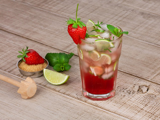 Strawberry mojito cocktail over wooden background