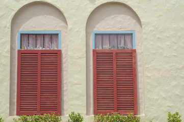 Fototapeta na wymiar Red wooden window on vintage home.