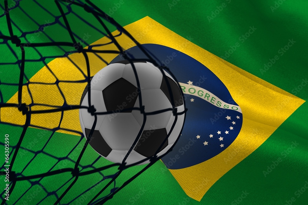 Poster Composite image of football in back of the net