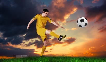 Composite image of football player in yellow kicking