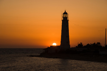 Bright sea sunset above the beacon