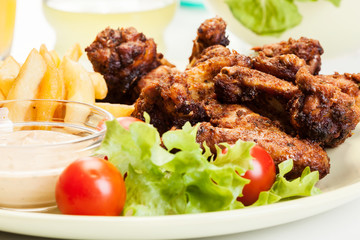 Chicken wings with fries french and spicy sauce