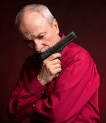 Senior man with a gun