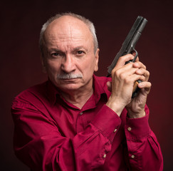 Senior man with a gun