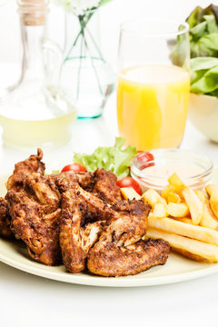 Chicken wings with fries french and spicy sauce