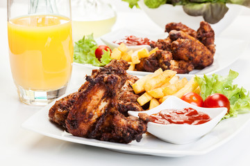 Chicken wings with fries french and spicy sauce