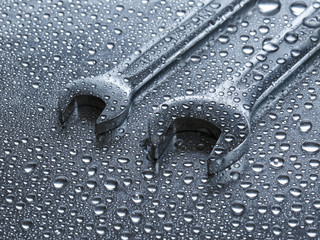 Wet spanners on metal background