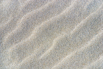 Fototapeta na wymiar rippled sand background or texture