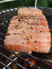 grilling fish on a charcoal grill