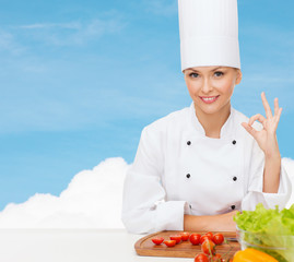 female chef with vegetables showing ok sign