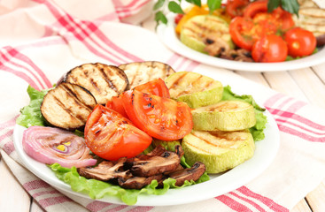 Delicious grilled vegetables on plate on table close-up