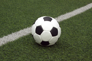 White and black ball for playing soccer near line close-up