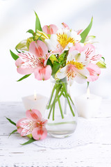 Obraz na płótnie Canvas Alstroemeria flowers in vase on table on light background