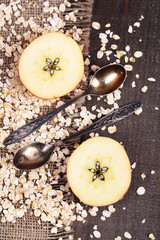 Apple with oatmeal and vintage spoons