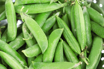 Fresh green peas in colander, close-up