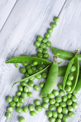 Fresh green peas on wooden background