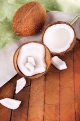 Fototapeta na wymiar Broken coconut with napkin on wooden background