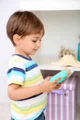 Cute little boy playing in room