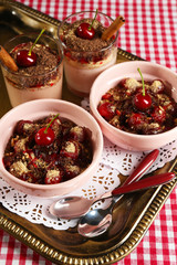 Tasty cherry dessert on table