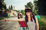 Two Tourist Girl Hitchhiking