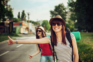 Two Tourist Girl Hitchhiking