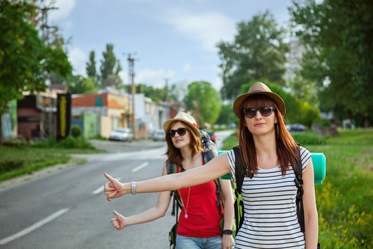 Two Tourist Girls Hitchhiking