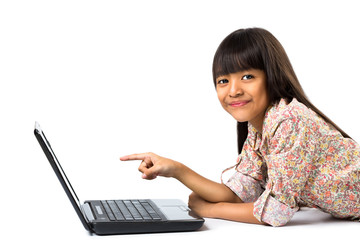 Smiling little asian girl with laptop computer