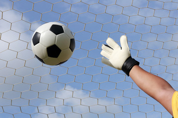 goalkeeper's hands reaching for foot ball
