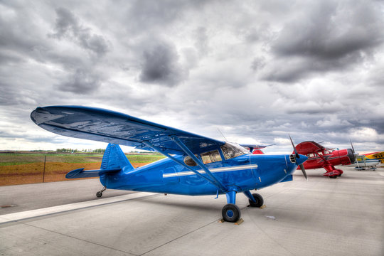 Vintage Planes on an Airport Tarmac. - Powered by Adobe