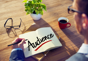 Businessman Writing the Word "Audience"