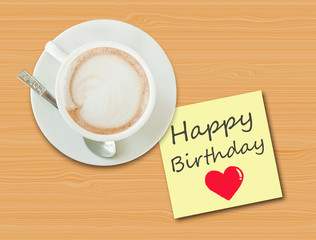 Coffee cup on wood table with paper note