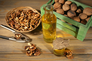 Walnut oil and nuts on wooden table