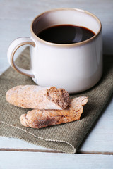 Cup with hot coffee and roasted coffee grains