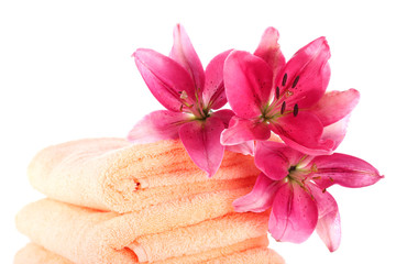 Obraz na płótnie Canvas Color towels and lily flowers, isolated on white