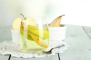 Sangria drink in glass on wooden table, on light background