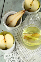 Sangria drink in glass and jar on wooden background