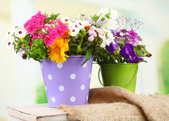 Bouquet of colorful flowers in decorative buckets,