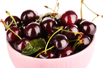 Sweet cherries in color bowl isolated on white