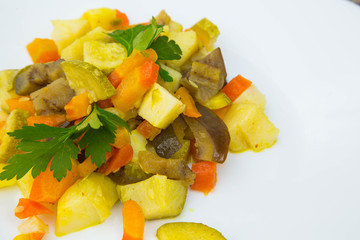 Stewed vegetables with curcuma on the white plate