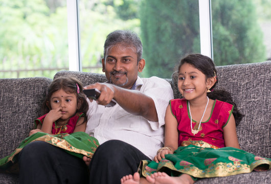 Indian Father Watching Tv With His Daughter On Living Room