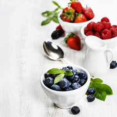 Berries in bowls  on Wooden Background.