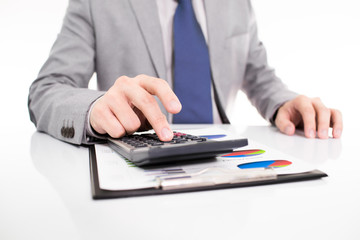 Businessman analyzing investment charts with laptop