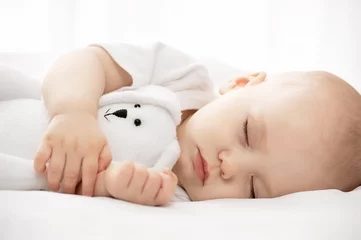Fototapeten Carefree sleep little baby with a soft toy on the bed © Alexandr Vasilyev