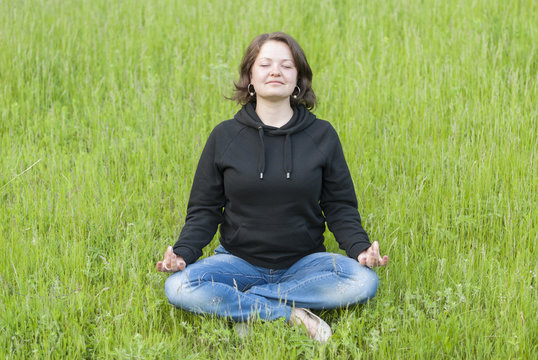 Woman meditating in the lotus position.
