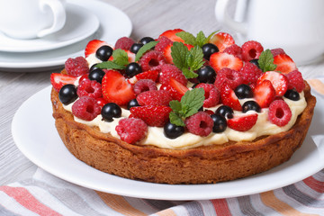 fresh berry tart with strawberries, raspberries and mint closeup