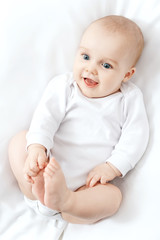 Portrait of happy baby on the bed